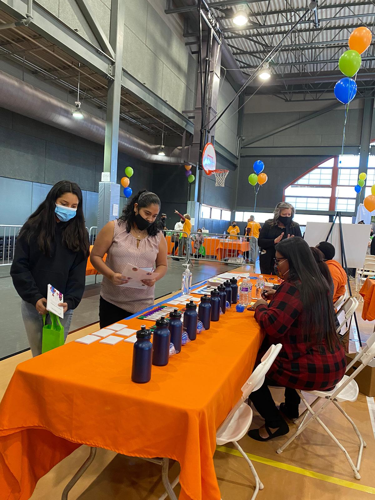 event banquet table with people looking at items