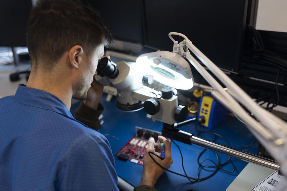 Person working on technology under bright light