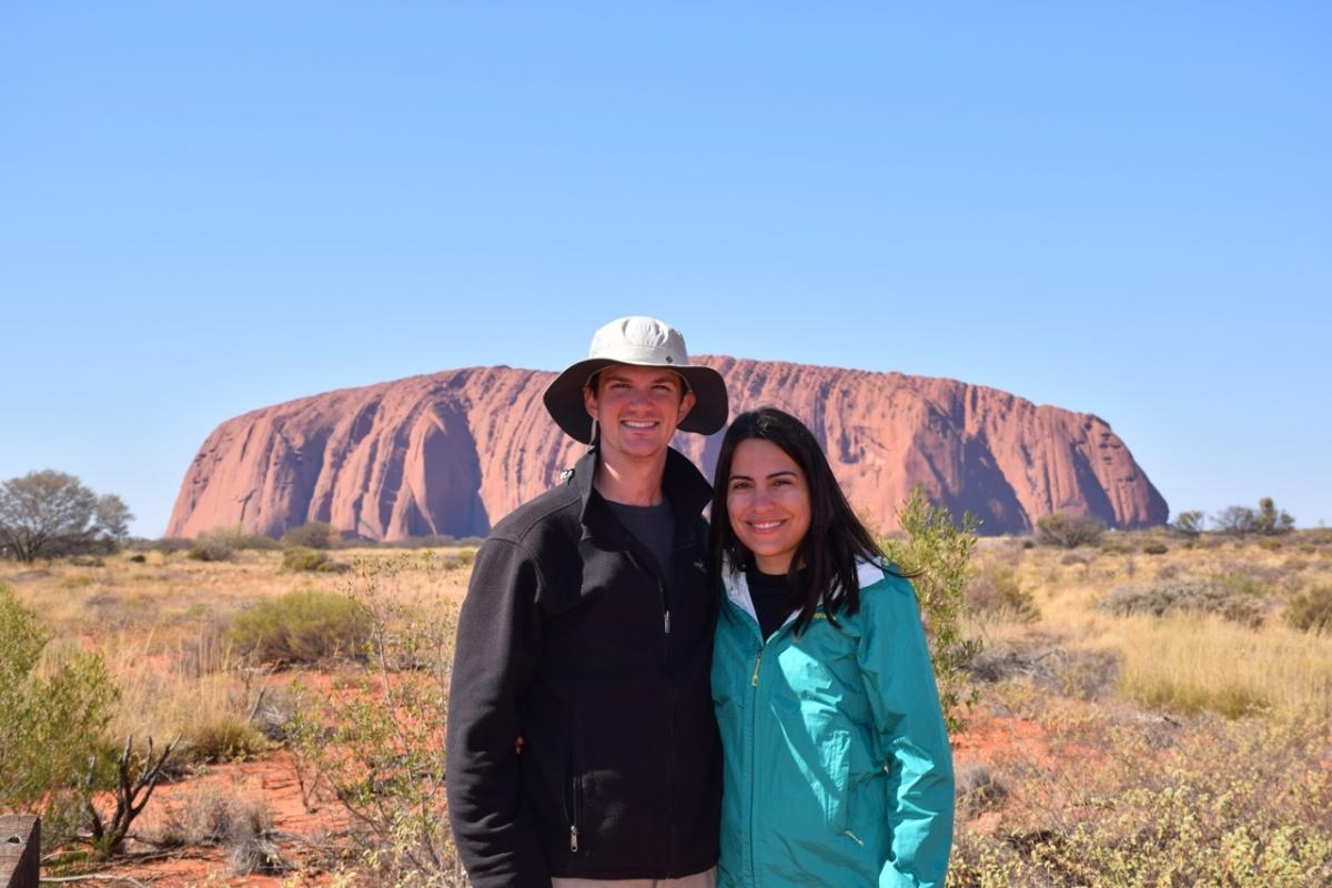 two people posing in front of landscape