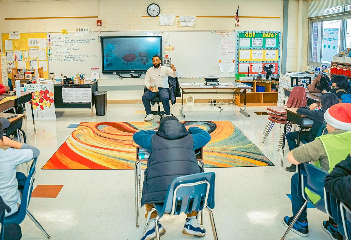 Jalen Roddey sat on a chair talking to a class of students 