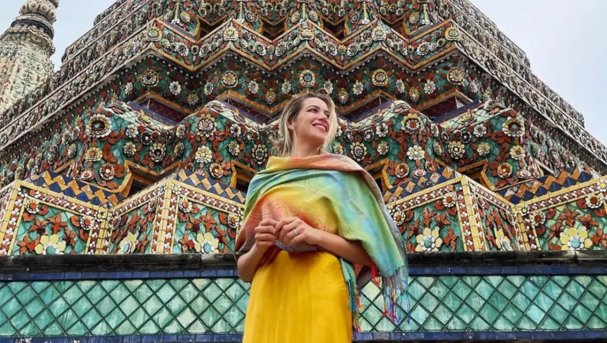 Karla Huerta in front of a colorful building.