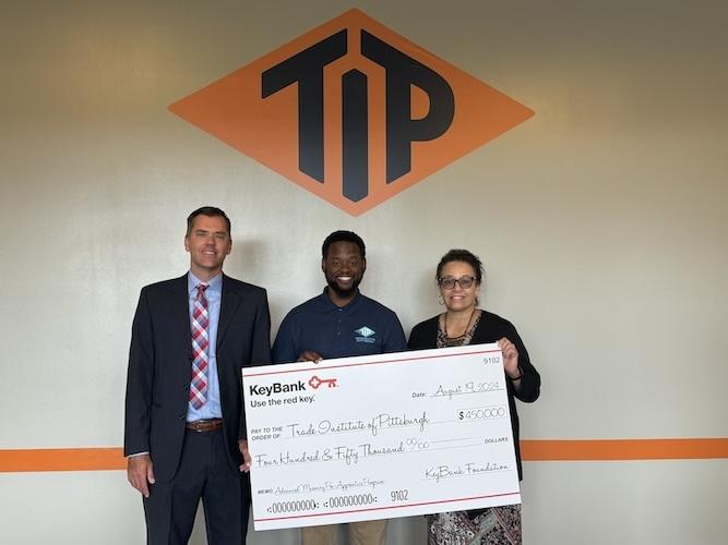 KeyBank and representatives from TIP shown holding a $450,000 grant check.