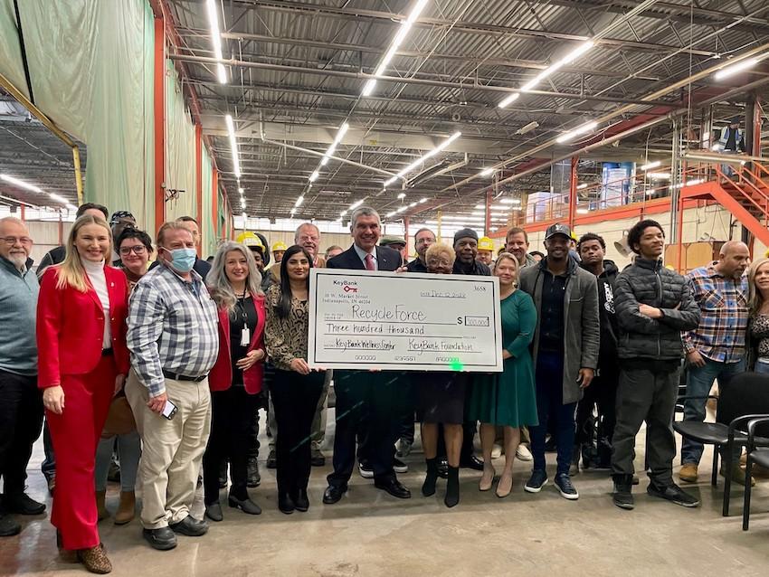 KeyBank and RecycleForce employees shown holding the $300,000 grant.