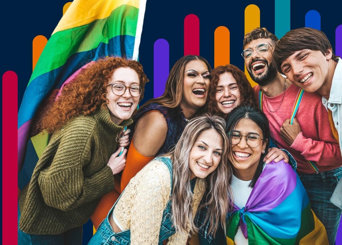 Group of seven people with a Pride flag in the background.