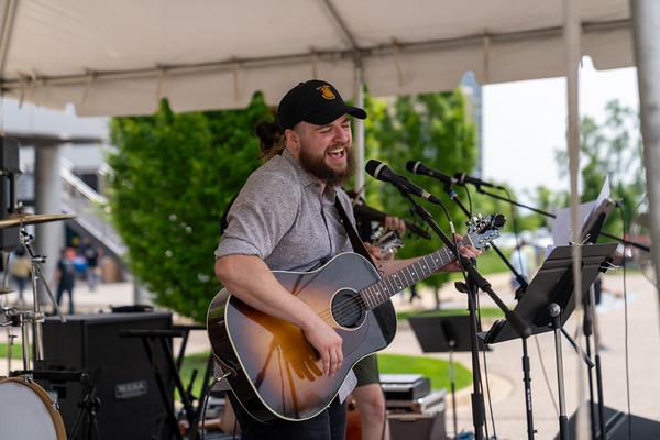  A person playing an acoustic guitar on stage.