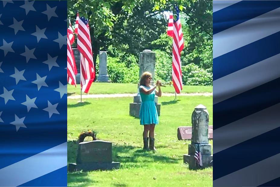 Marianne Masters playing a trumpet in a cemetary.