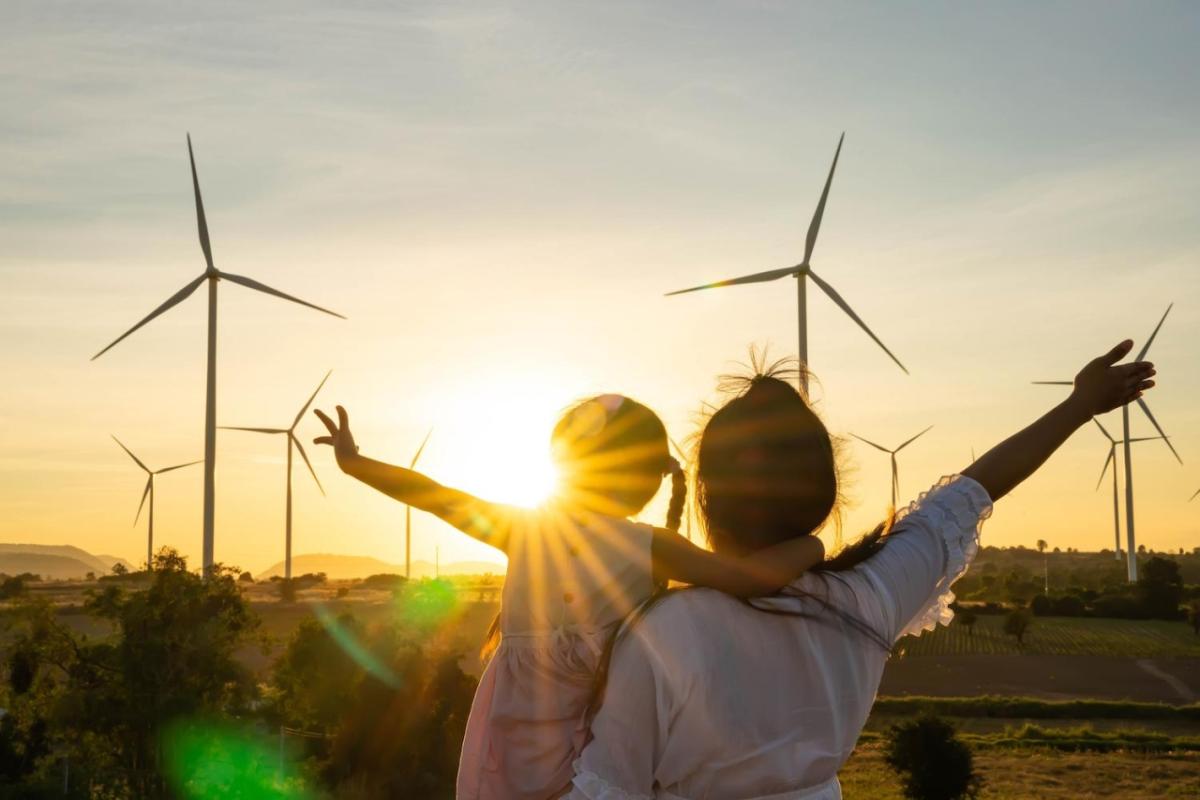 Parent and child looking windfarm