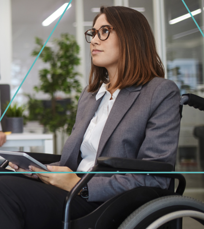 A person sitting in a wheelchair, using an electronic tablet