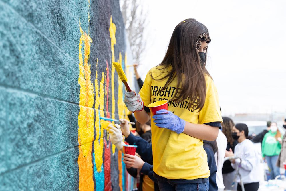 Volunteer working on the mural