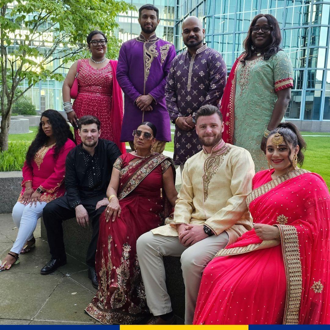 A group posed in AAPI cultural garments.