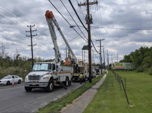 Cherry picker truck preparing to work on electrical wires.