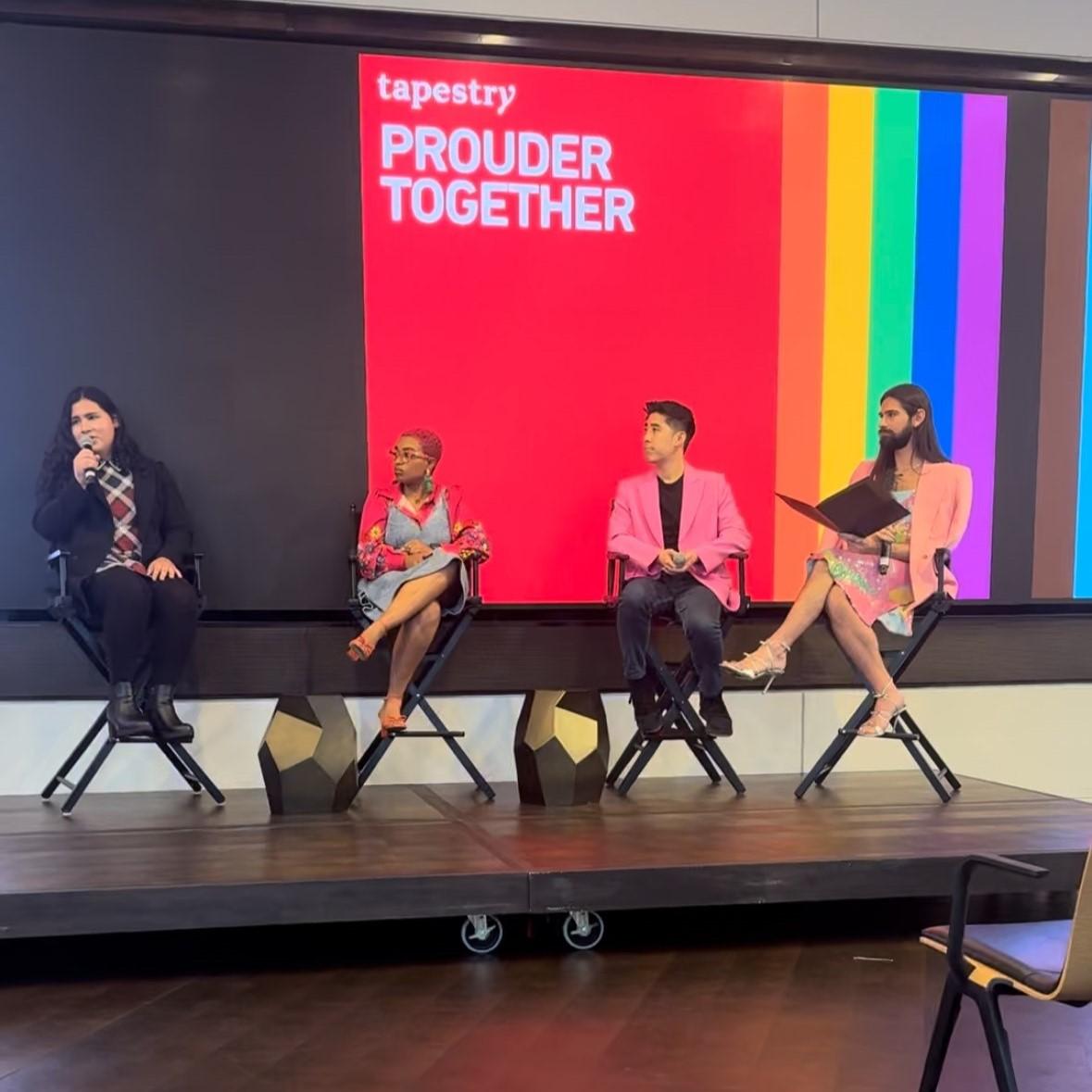 Panelists Salem Vazcones of the Hetrick-Martin Institute; Kevin Wong of the Trevor Project; Dr. Vivid (Dr. Ashley Elliott), a licensed clinician and youth advocate; and RJ Crossley, Prouder Together EBRG lead and Stuart Weitzman Store Manager sitting in director chairs in front of a LGBTQ+ banner