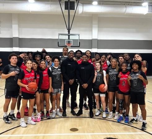 Rise League basketball team shown with the two coaches.