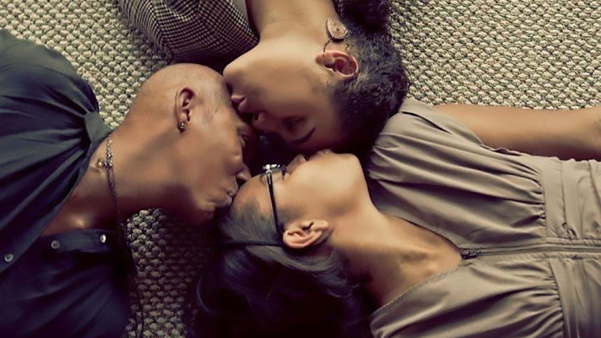 Ricki with her two daughters, Amanda and Hayley lying on the floor, kissing each others' foreheads