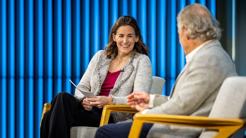 Sara Cronenwett and another seated on a stage.