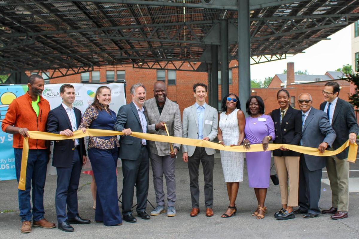 Group of people at ribbon cutting celebration for the completion of the solar array at Sargent Memorial Presbyterian Church