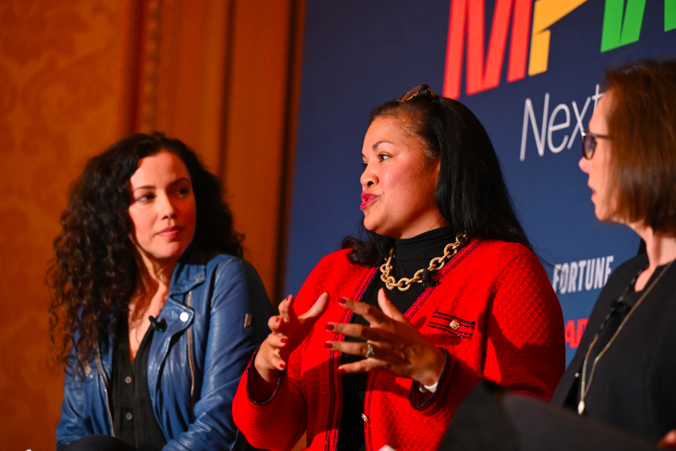 Three women speaking on a panel