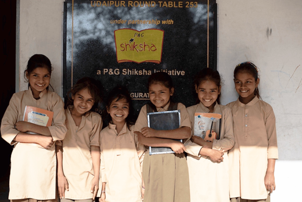 school girls in front of sign