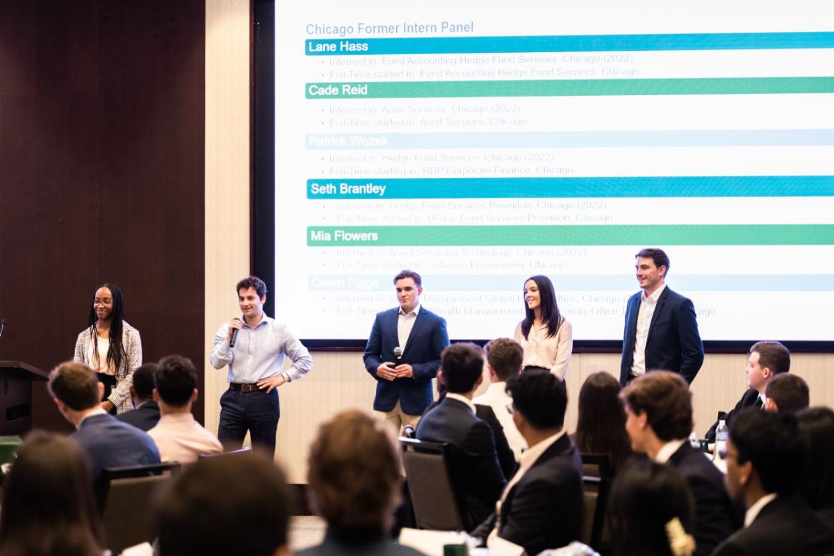 group of interns standing in front of room