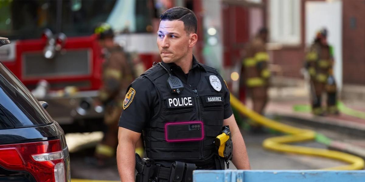 Policeman standing near firefighters on a city street