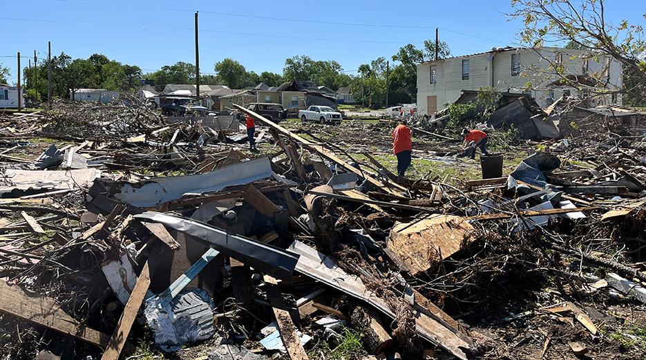 The Home Depot Foundation volunteers shown working through tornado damage in a community. 