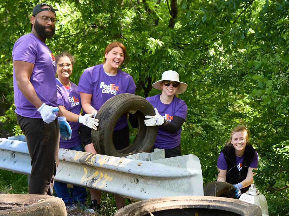 Group of Volunteers holding a tire