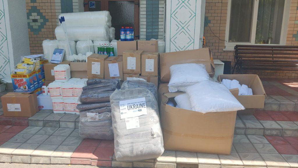 on a front porch, piles of cleaning supplies, boxes