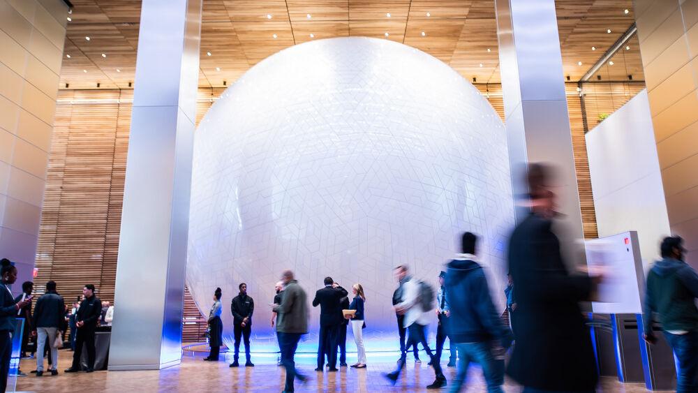 The Universal Sphere and many people walking around.