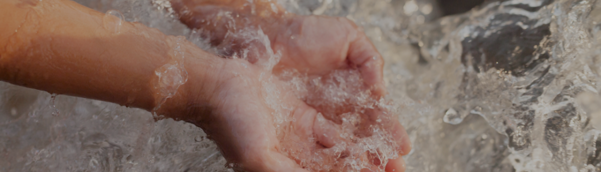 Child's hand scooping splashing water