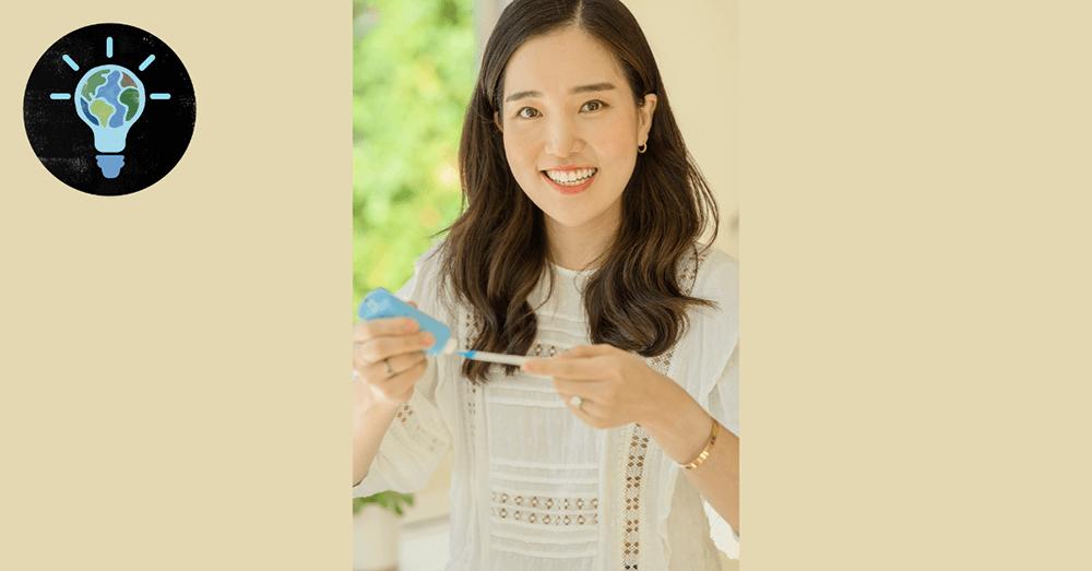 Vicki Jung in a home setting, putting toothpaste on a brush.