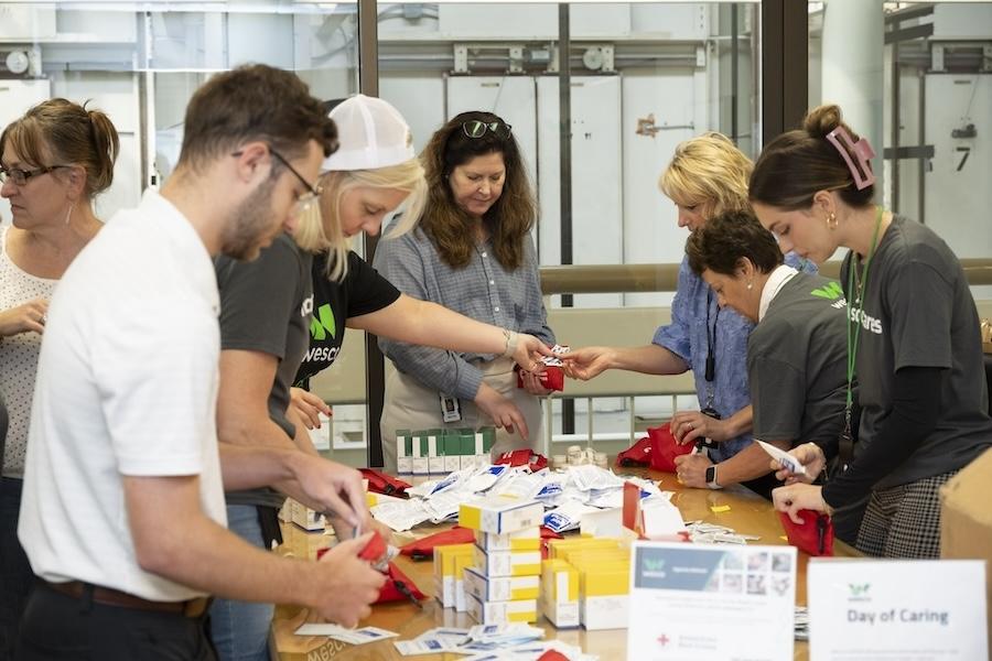 Wesco volunters sorting supplies prior to packing them.