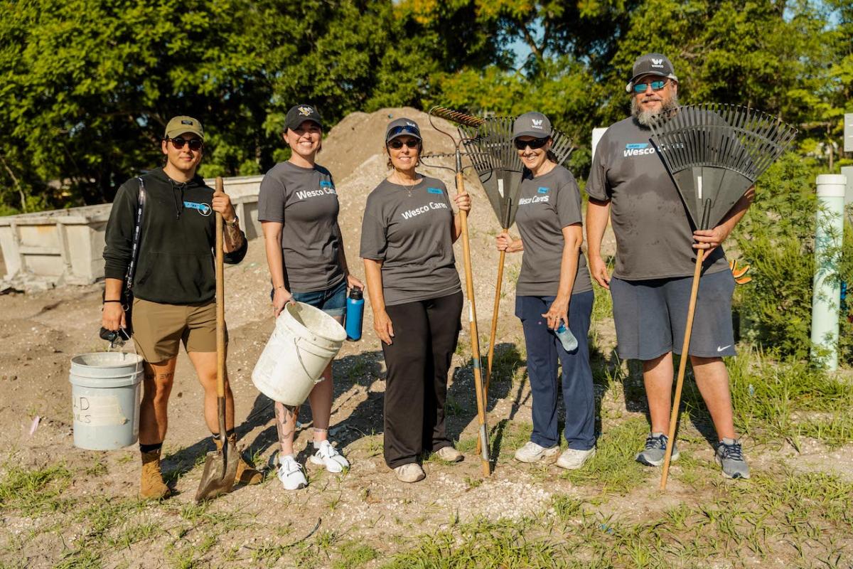 Wesco team members doing yardwork.