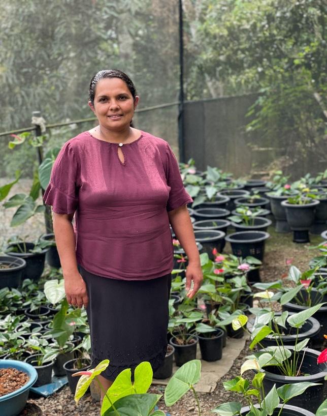 Widya with lots of potted plants