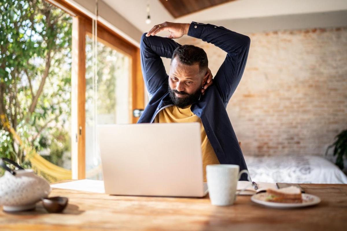 Man Stretching at Desk