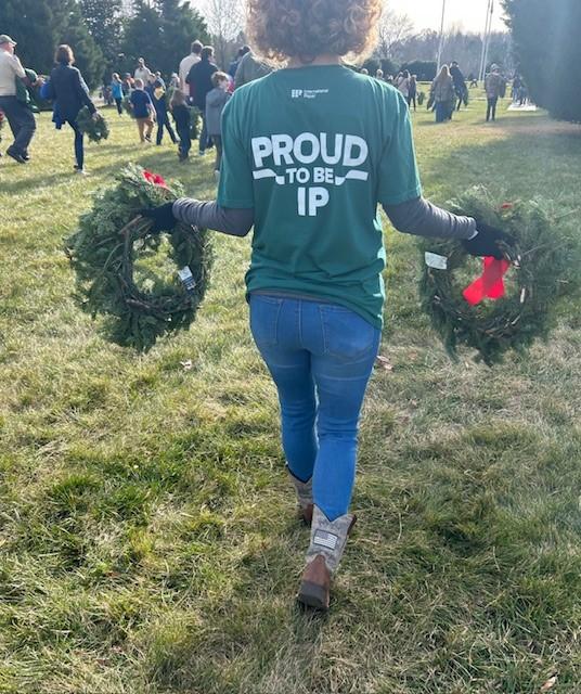 person holding up wreaths