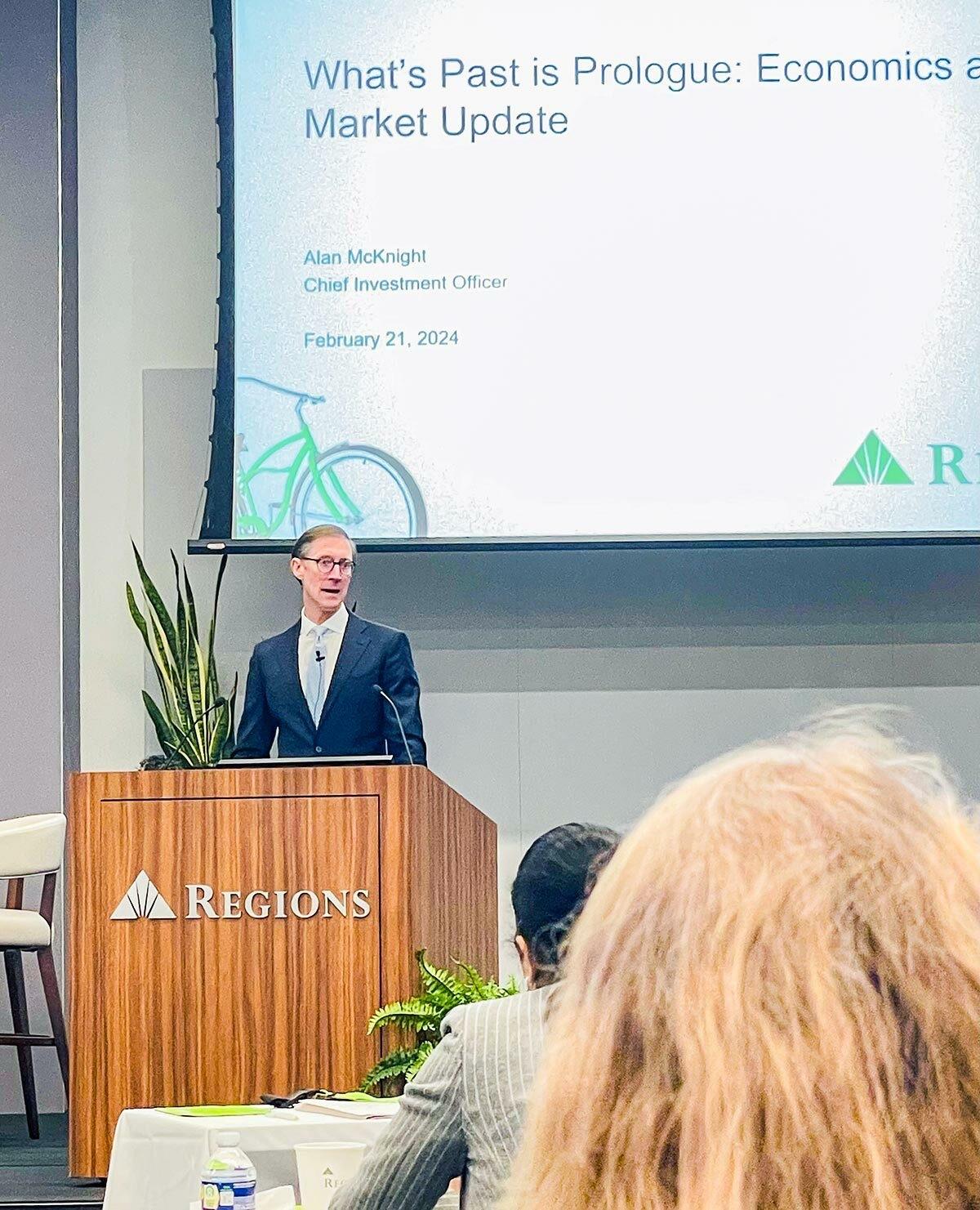 A person stood on stage speaking at an event