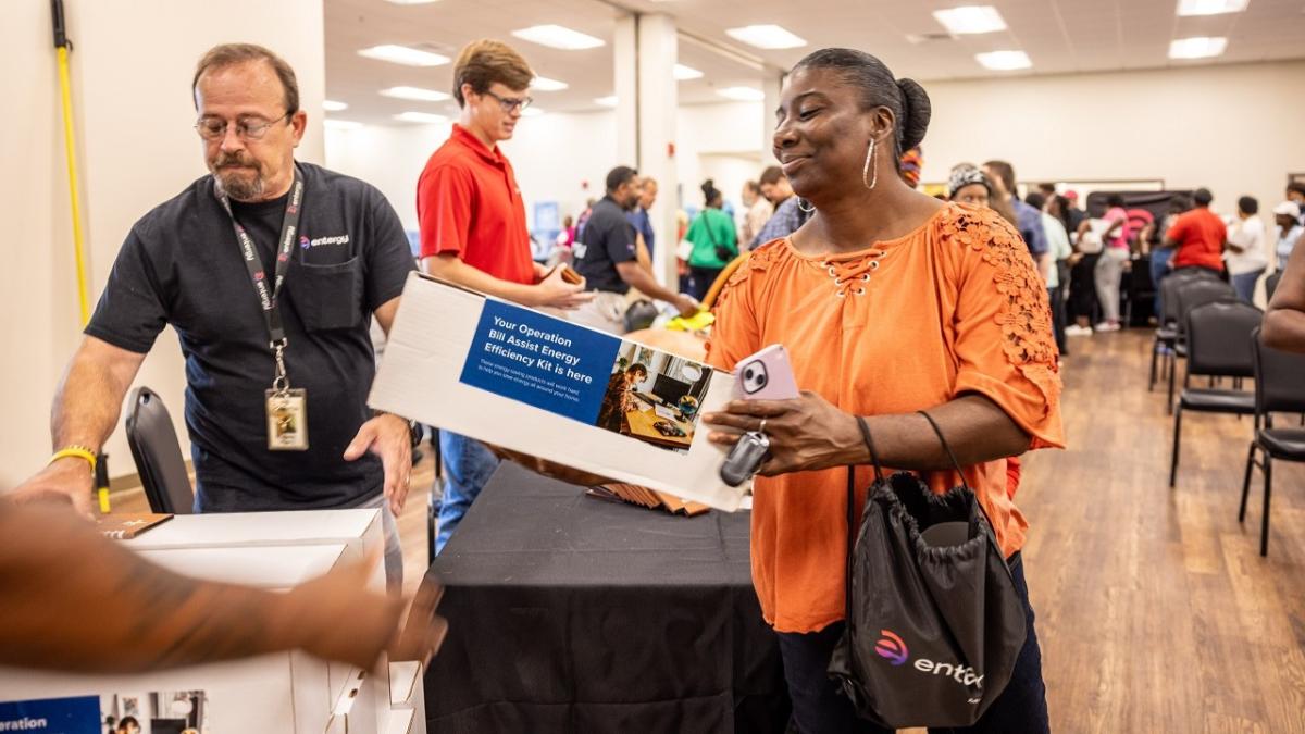 A person receiving an energy saving kit at the event.