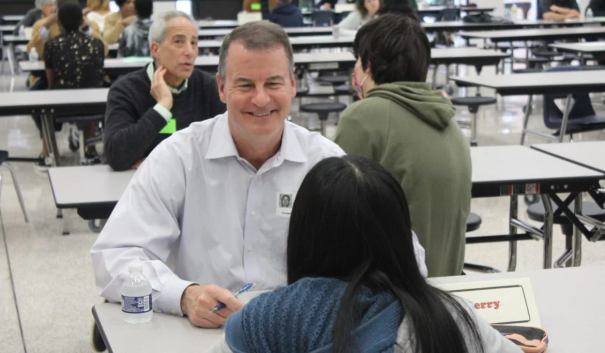 GP employee Bob Berry talking with a student