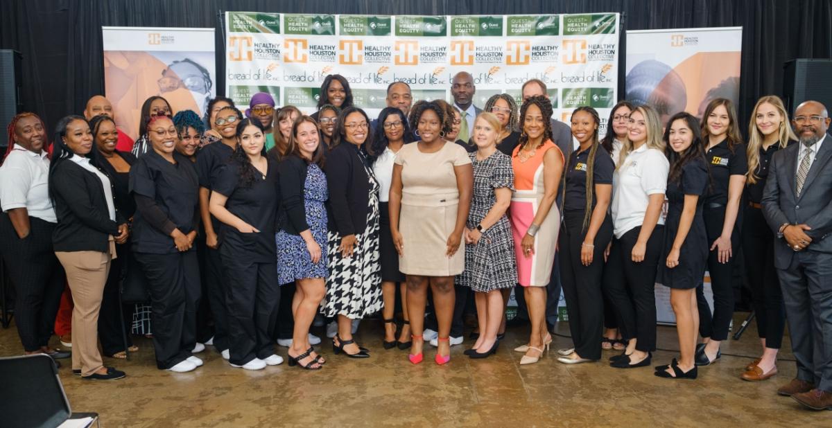 Group of people in front of a Healthy Houston Collective banner