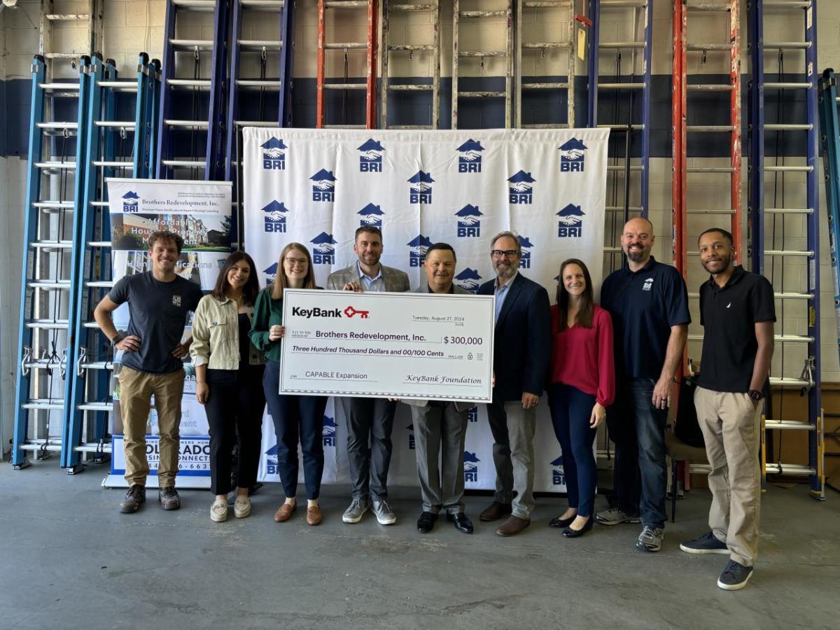 People posing with an oversized check