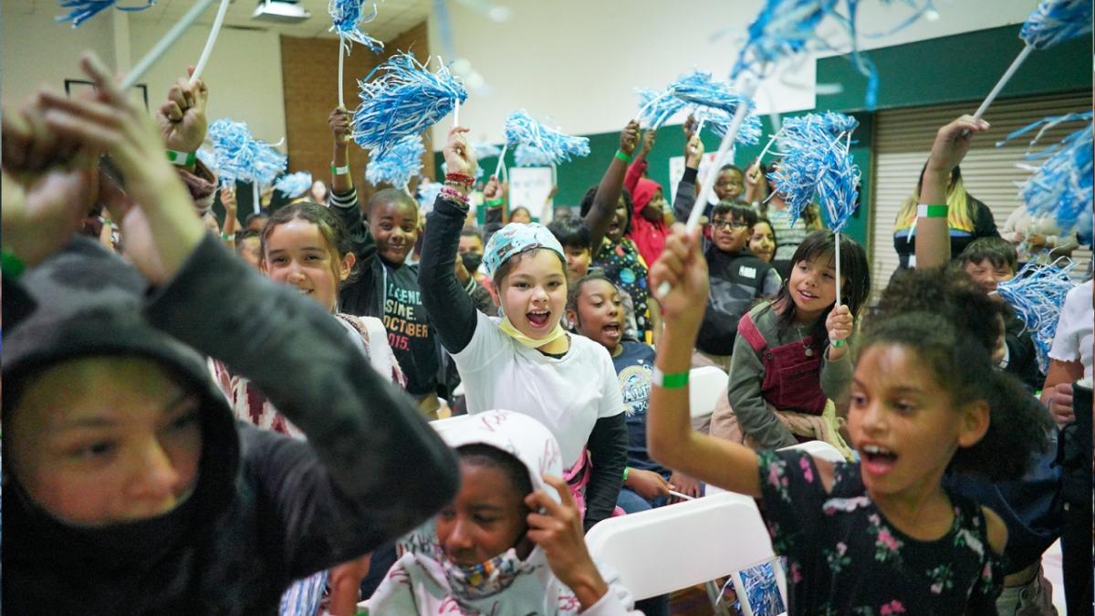 Youth at Astronaut José M. Hernandez Academy cheering at a Project UP digital equity grant announcement in Stockton.