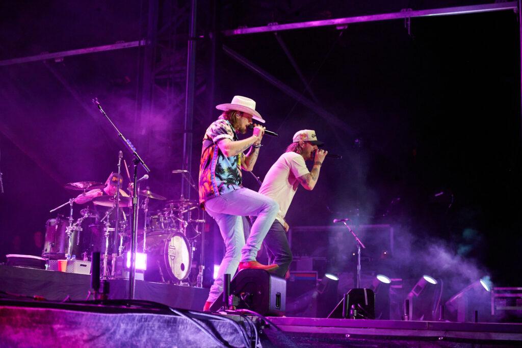 close up of lead singers of the band "Florida Georgia Line", lit up stage with fog effect