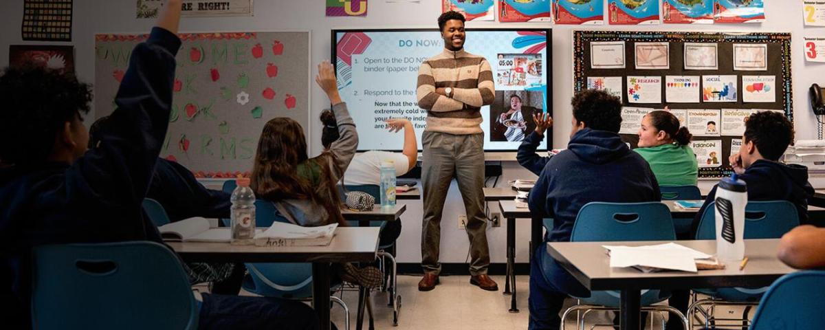 A teacher instructs his class of students 