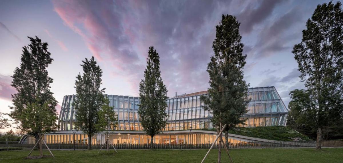 Exterior view of the Olympic House and trees in front.