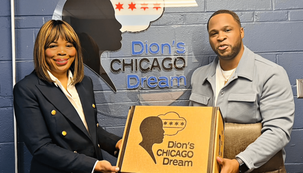 Two people holding a box "Dion's Chicago Dream" on the front and on the wall behind them.