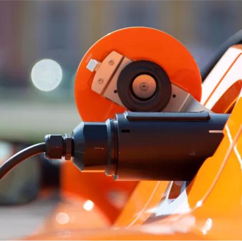 close up of e-vehicle charge port plugged in