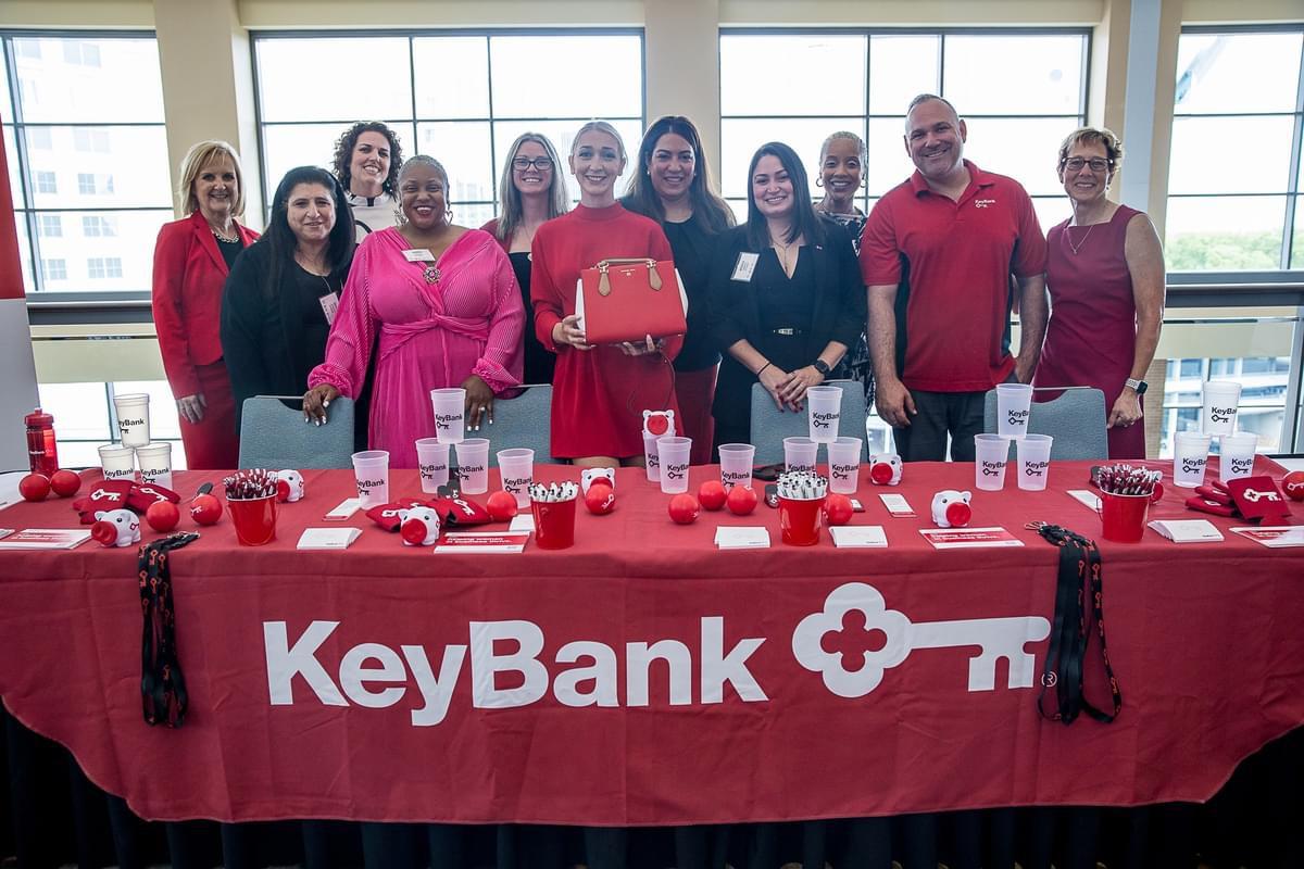 People standing behind KeyBank's event booth