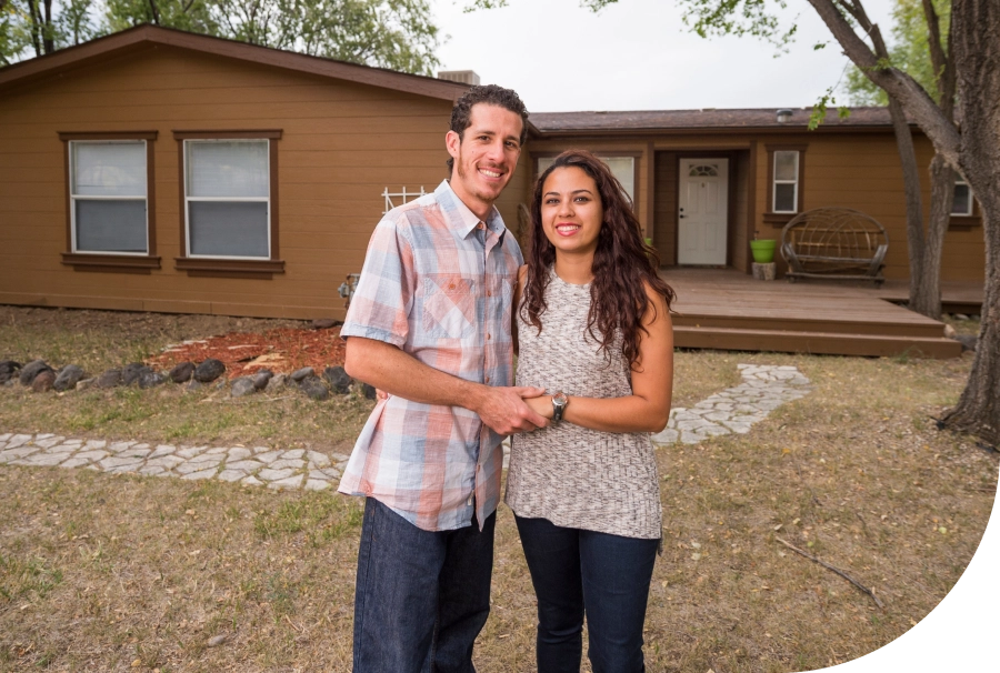 Couple standing in front of a house