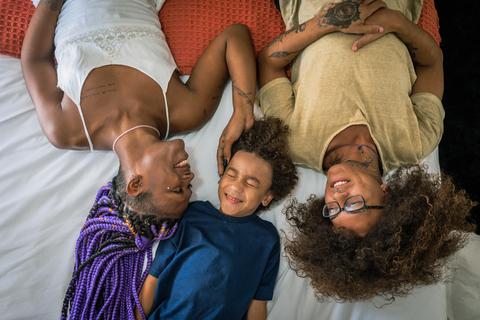 Family laying in bed