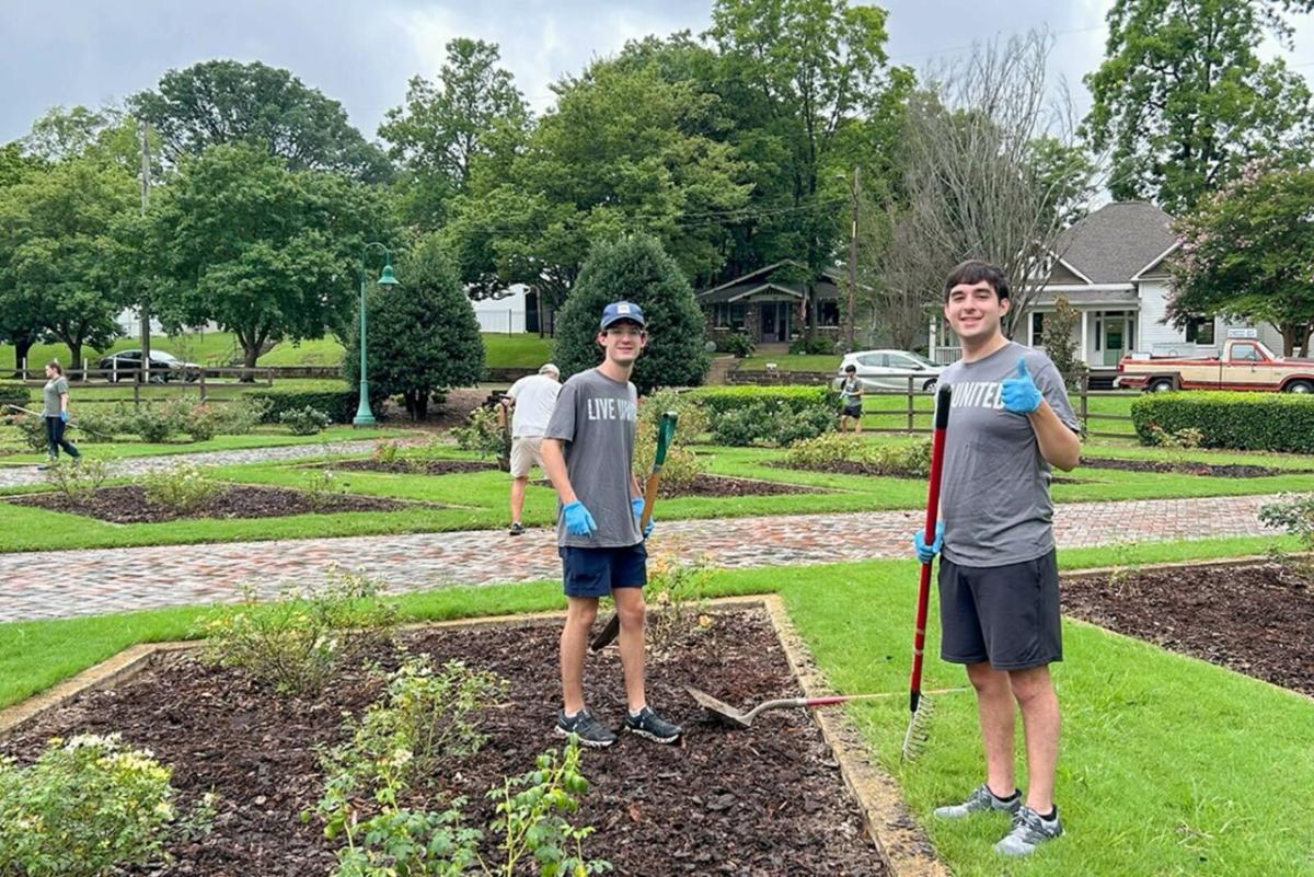 Two intern volunteers gardening.